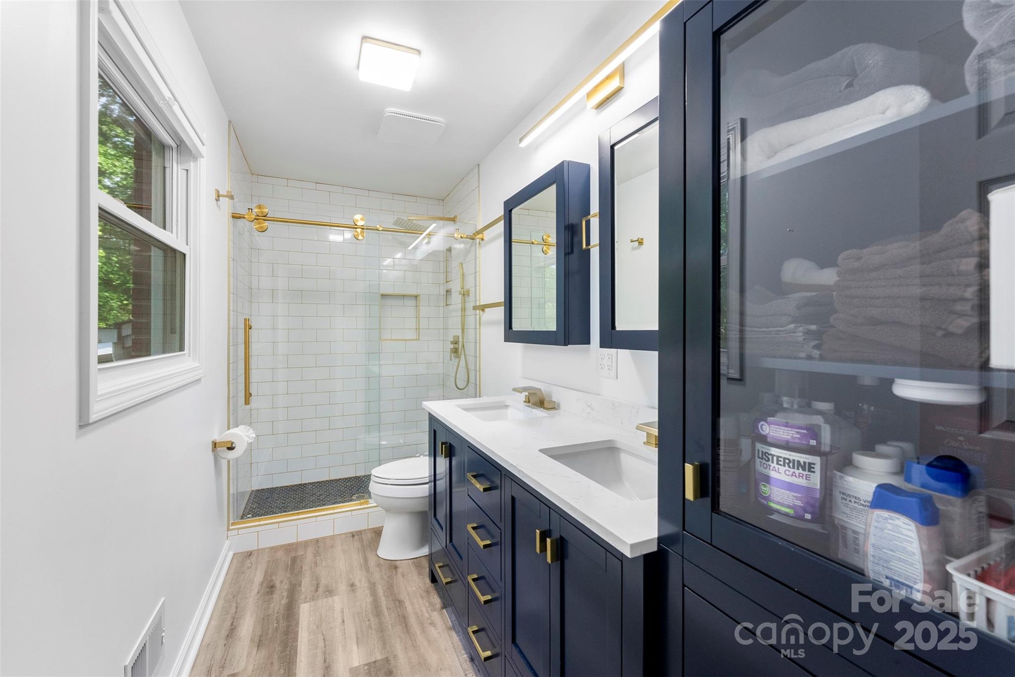 1822 North New Hope Road Gastonia, NC 28054 - Photo 35 of 47 a spacious bathroom with a sink a toilet a shower and a mirror