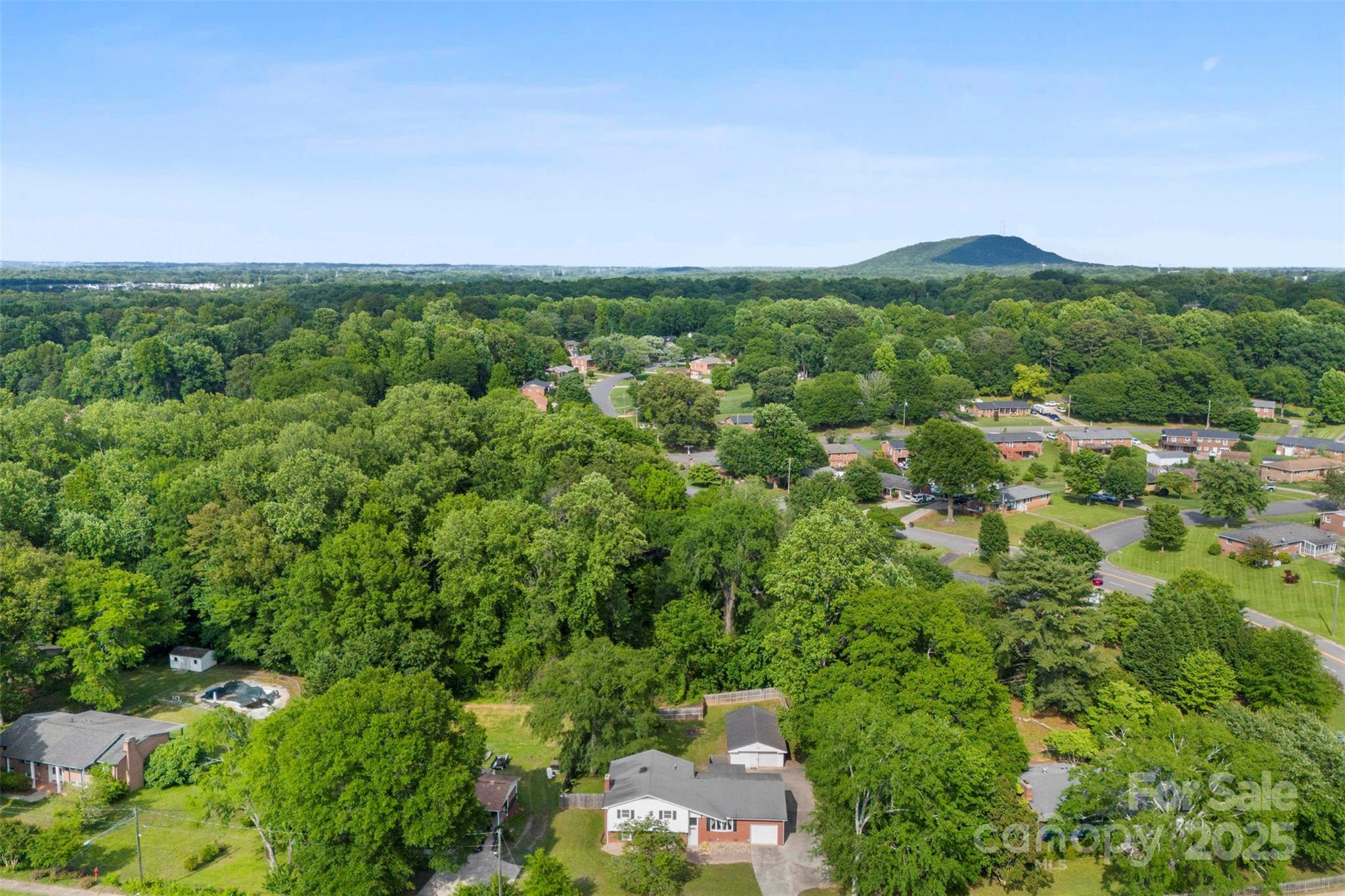 1822 North New Hope Road Gastonia, NC 28054 - Photo 5 of 47 an aerial view of a houses with a lush green hillside