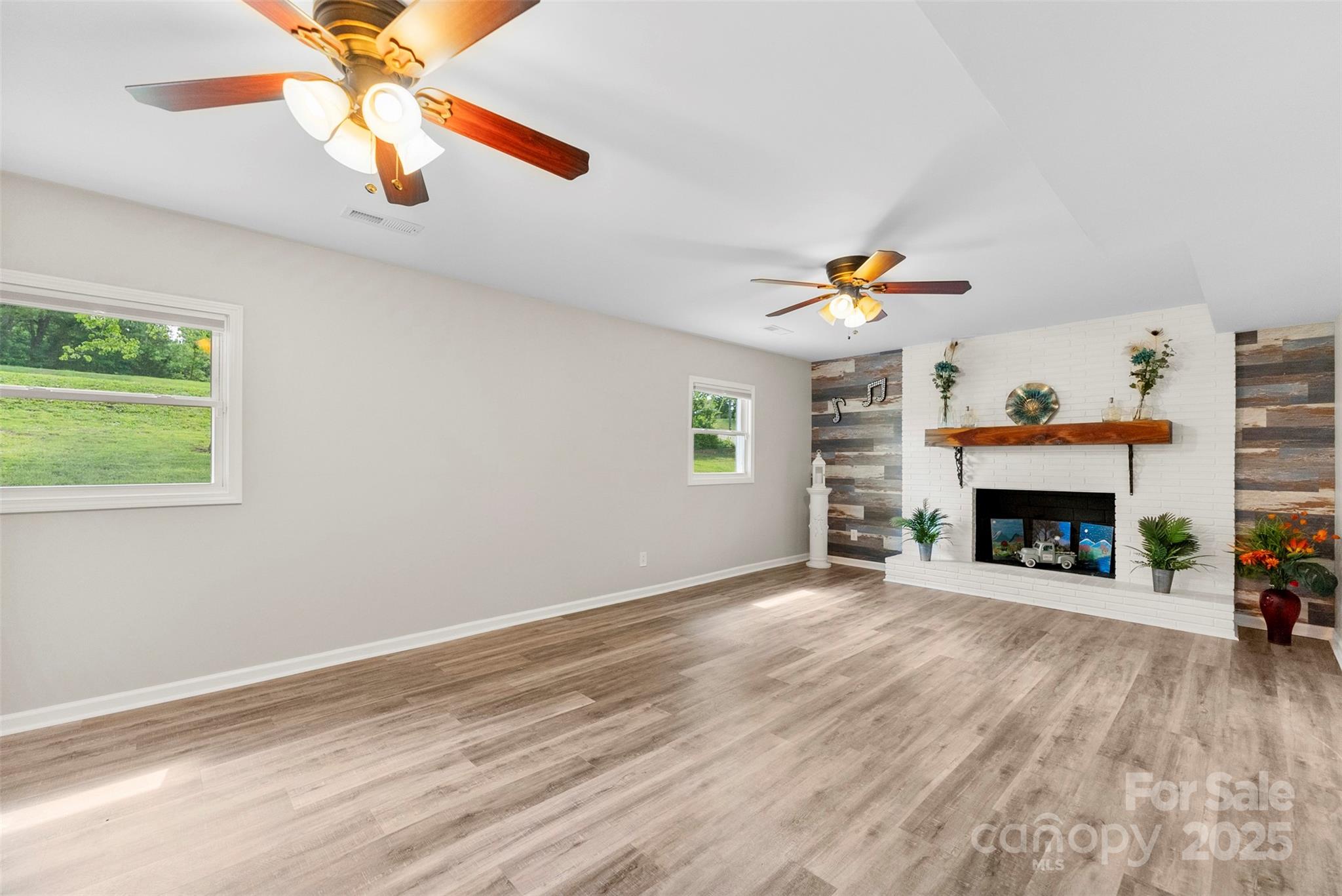 1822 North New Hope Road Gastonia, NC 28054 - Photo 10 of 47 a view of an empty room with a fireplace and a window