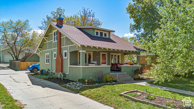 860 North 500 East Logan, UT 84321 - Photo 1 of 1 Bungalow-style house with roof with shingles, fence, covered porch, and a chimney
