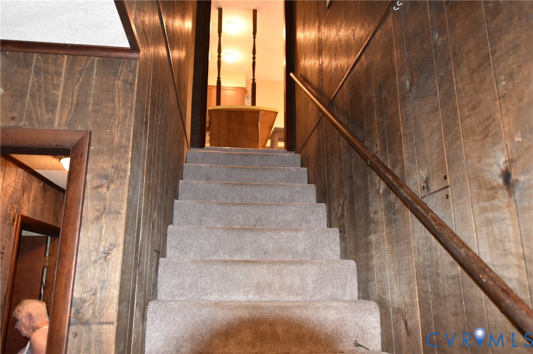 642 Star Street Pounding Mill, VA 24637 - Photo 10 of 20 Carpeted staircase featuring a wood railing and pa