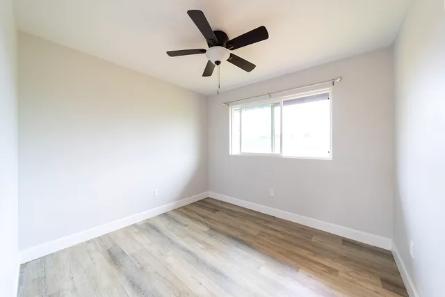 wooden floor in an empty room with a window