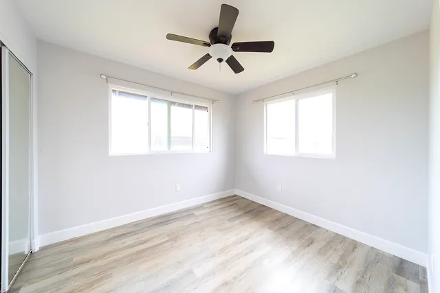 a view of room with ceiling fan and window