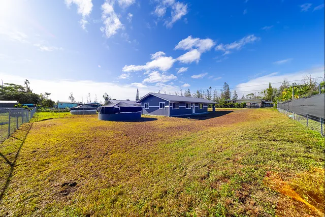 a swimming pool with outdoor seating and yard