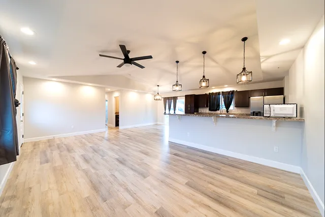a view of a kitchen with furniture and a ceiling fan