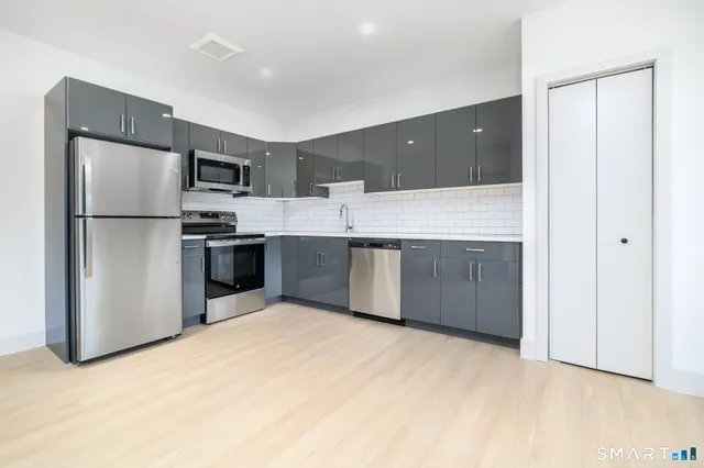 a view of a kitchen with a sink and dishwasher large window
