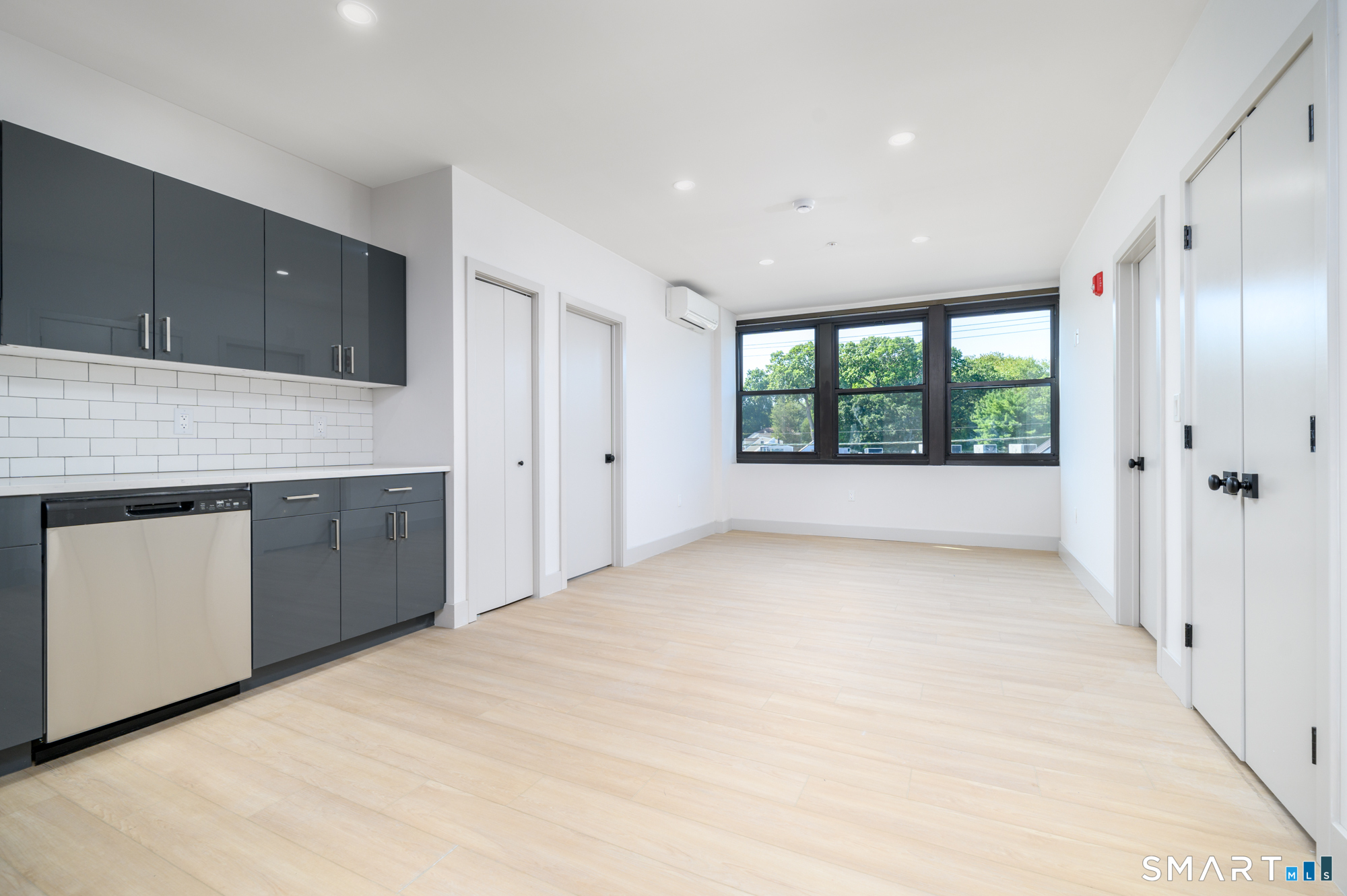 1011 High Ridge Road, Unit 2H Stamford, CT 06905 - Photo 4 of 5 a view of a kitchen with a sink and dishwasher large window