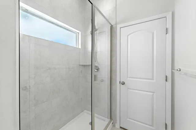 a bathroom with a glass shower door