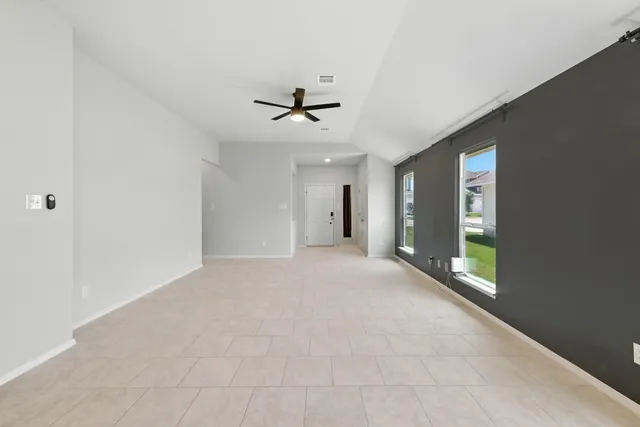 a view of an empty room with a ceiling fan