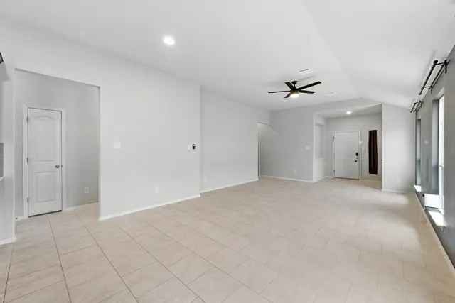 a view of a livingroom with a ceiling fan and window