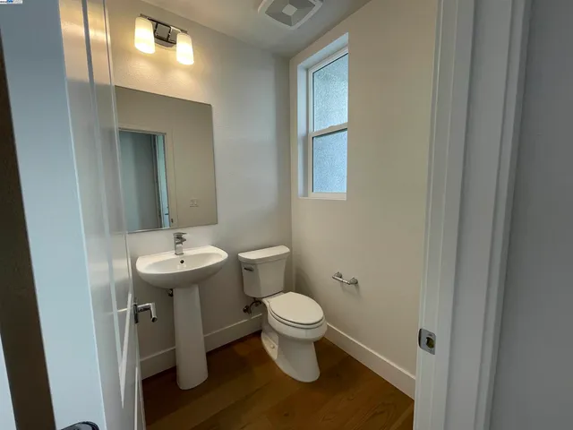 a bathroom with a sink toilet and a mirror