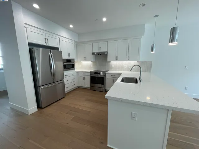 a kitchen with refrigerator and stove
