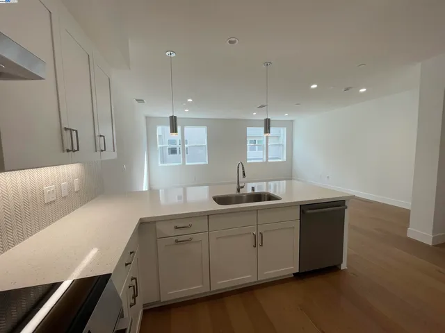 a spacious bathroom with a double vanity sink and mirror