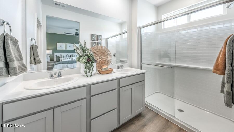 1029 Middle Gate Road Carson City, NV 89701 - Photo 20 of 25 a bathroom with a double vanity sink mirror and shower