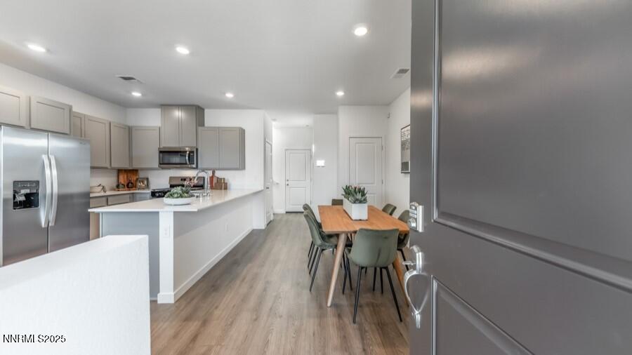 1029 Middle Gate Road Carson City, NV 89701 - Photo 3 of 25 a kitchen with a refrigerator and a table