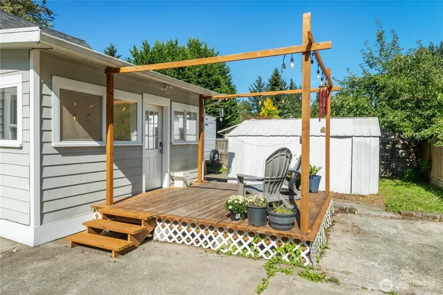 a view of a patio with table and chairs and potted plants
