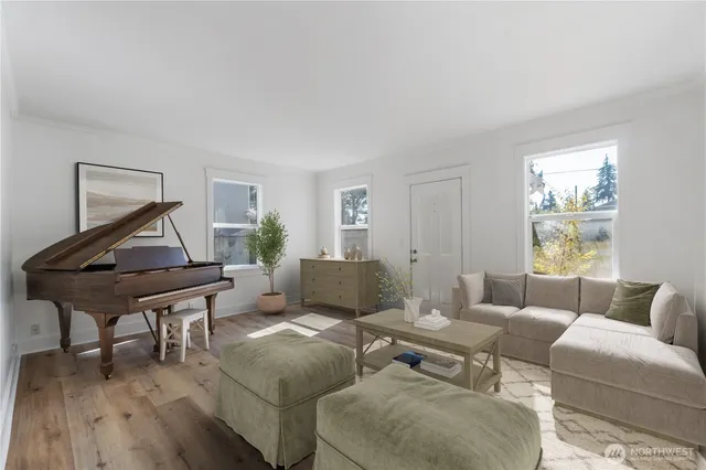 a living room with furniture and wooden floor