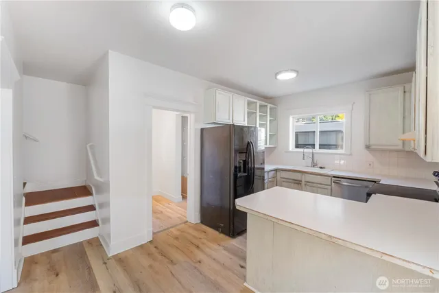 a kitchen with a refrigerator and a sink