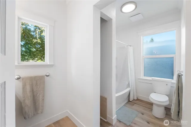 a bathroom with a toilet sink and a shower
