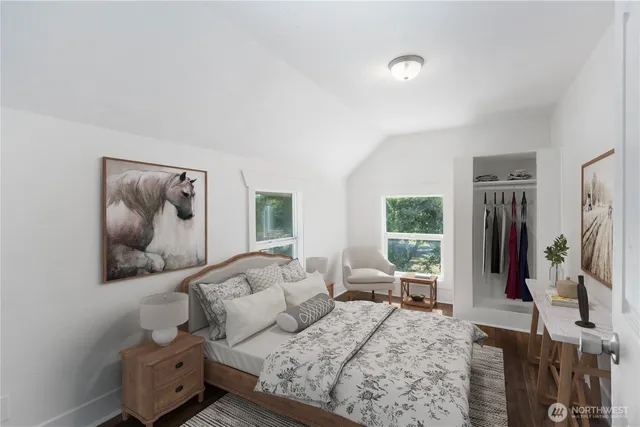 a bedroom with a large bed couch and a window