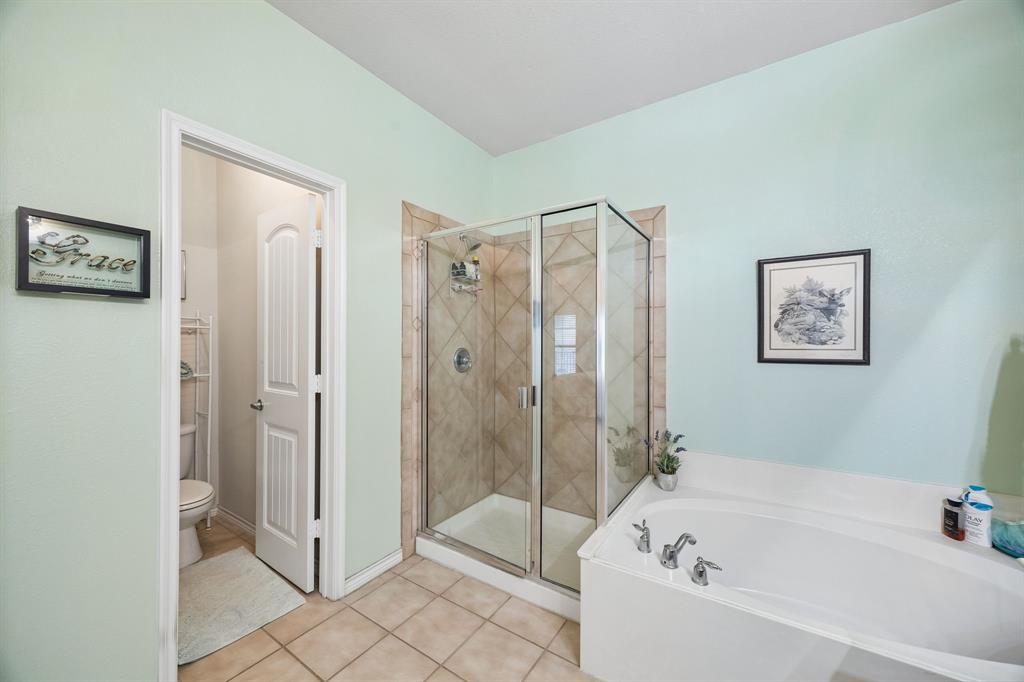 2003 Downing Street Allen, TX 75013 - Photo 25 of 40 Love this view of the Primary Bath - spacious soaking tub, immaculate separate shower and serene paint choices!