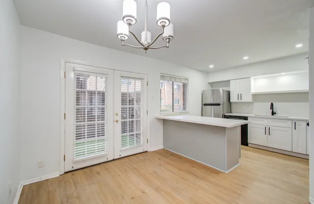 a view of kitchen with wooden floor and window
