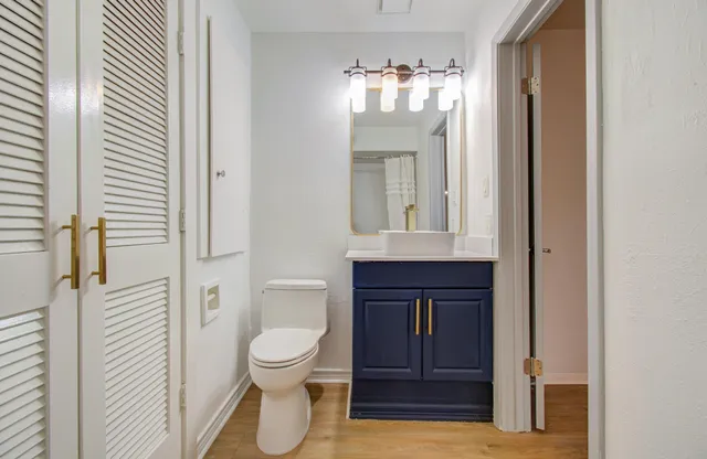 a bathroom with a toilet a sink and mirror