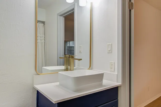 a bathroom with a sink and a mirror