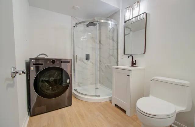 a bathroom with a toilet sink and shower