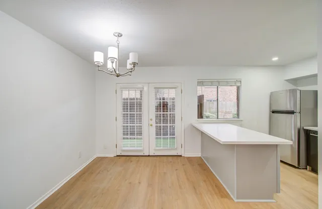 a view of kitchen with granite countertop cabinets a sink and stainless steel appliances