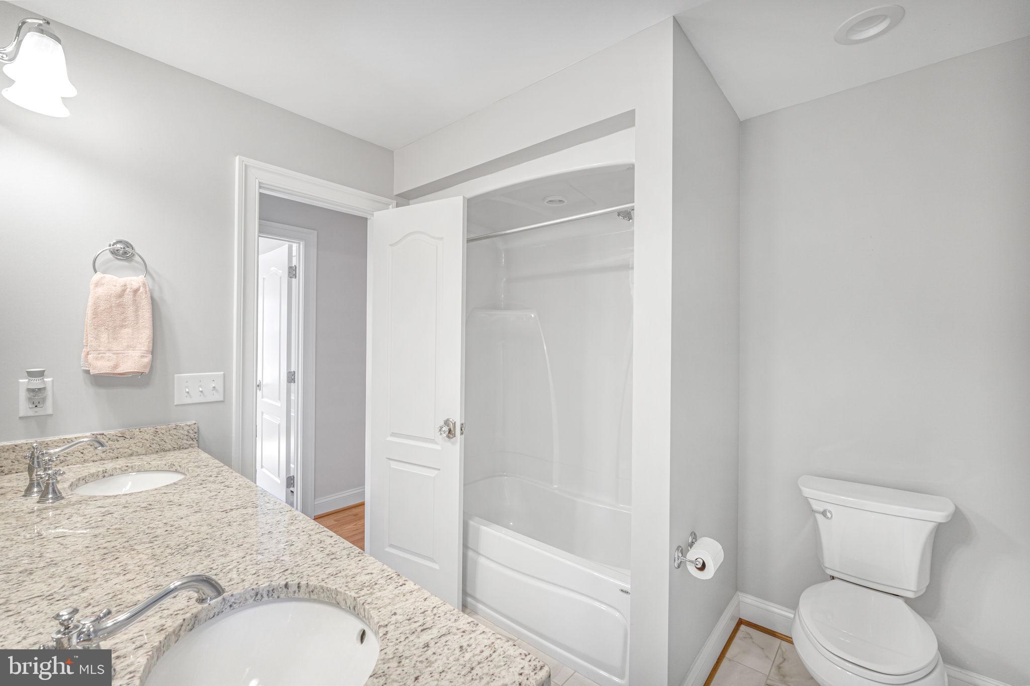 1185 Belle Meade Road Bumpass, VA 23024 - Photo 38 of 116 a bathroom with a granite countertop sink toilet and shower