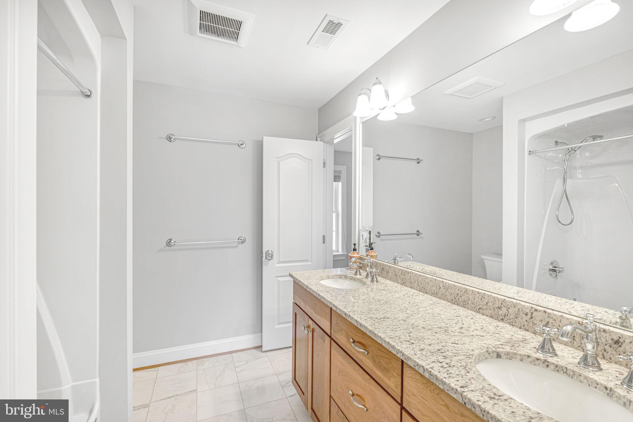 1185 Belle Meade Road Bumpass, VA 23024 - Photo 39 of 116 a bathroom with a granite countertop sink and a mirror