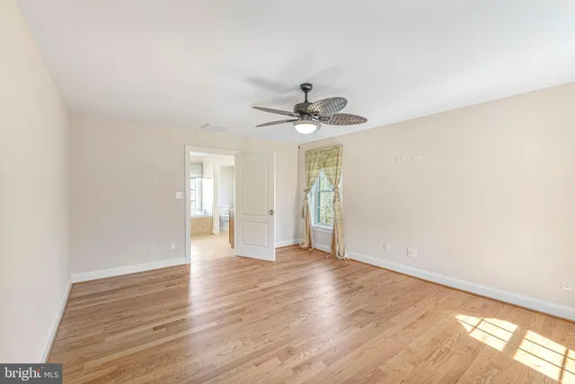 a view of a house with a small yard and large trees