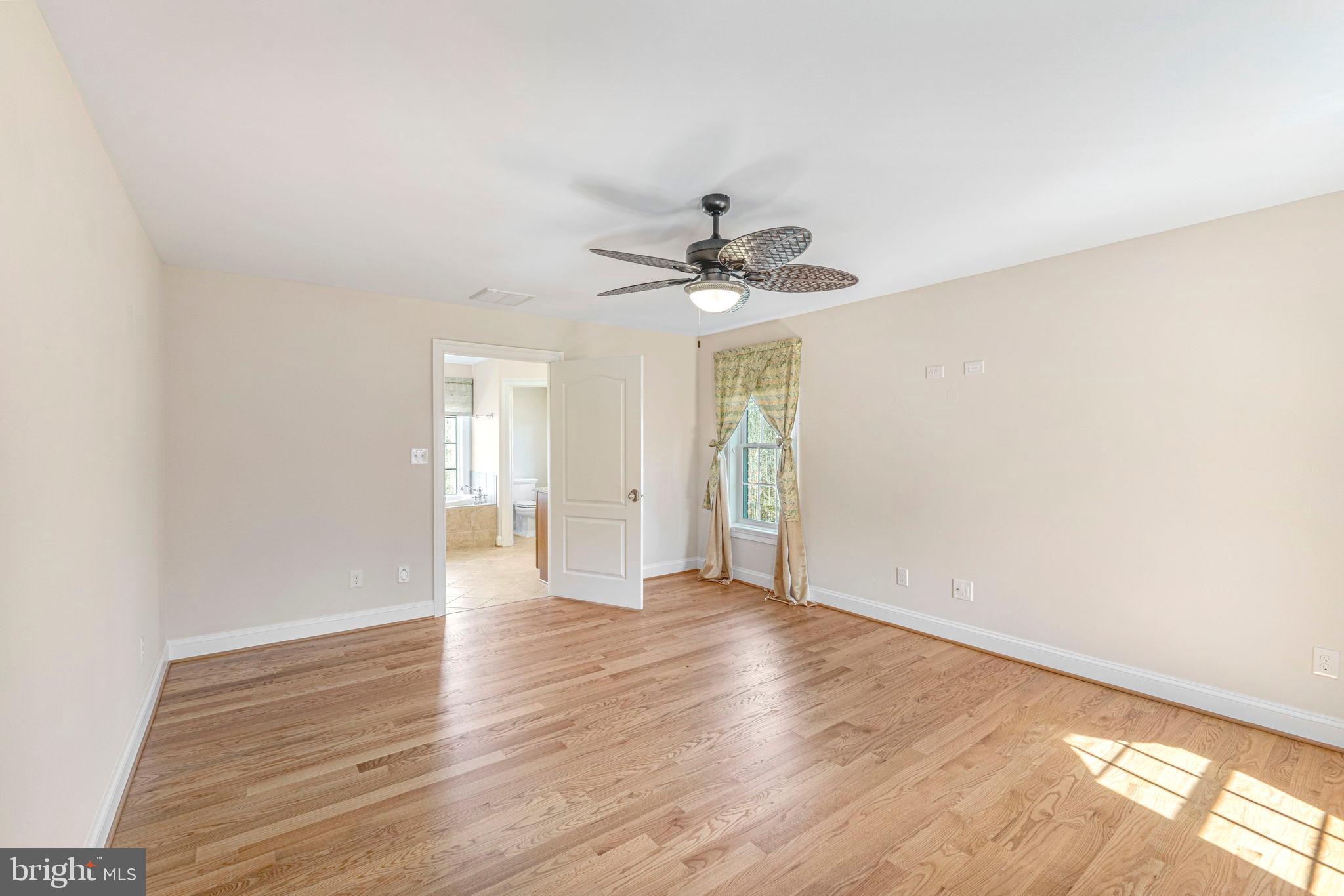 1185 Belle Meade Road Bumpass, VA 23024 - Photo 44 of 116 a view of an empty room with window and wooden floor