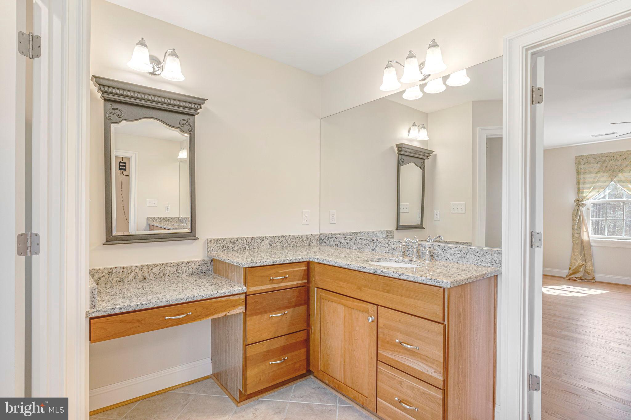 1185 Belle Meade Road Bumpass, VA 23024 - Photo 51 of 116 a bathroom with a granite countertop sink and a mirror