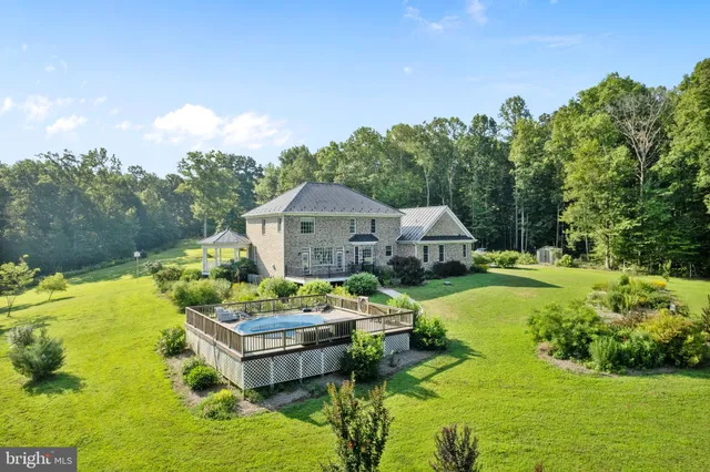 an aerial view of residential houses with outdoor space and trees