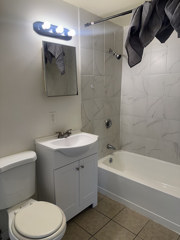 14 2nd Street, Unit 3 Lowell, MA 01850 - Photo 3 of 5 a bathroom with a toilet sink and mirror