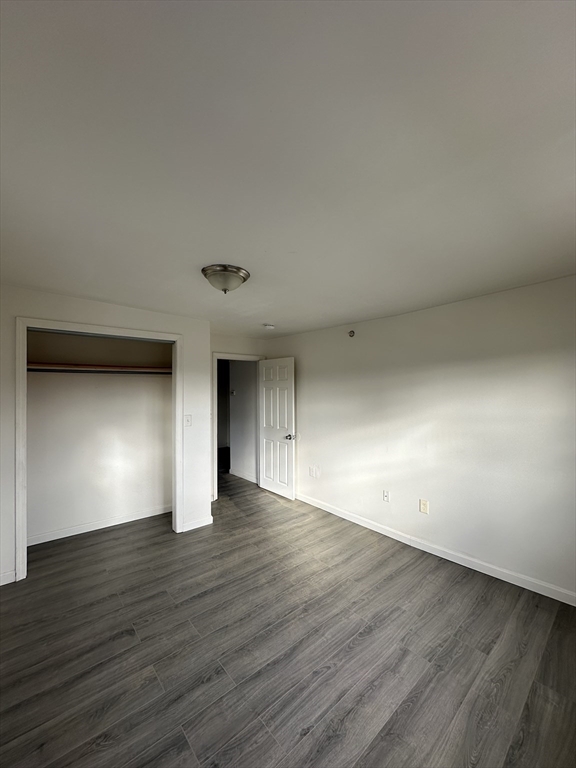 14 2nd Street, Unit 3 Lowell, MA 01850 - Photo 4 of 5 a view of an empty room with wooden floor