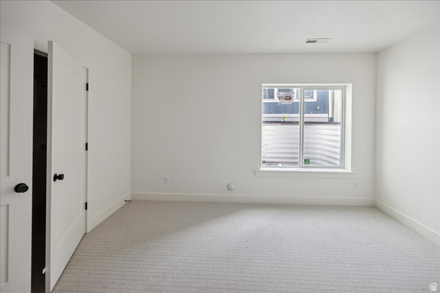 7189 South Sage Road, Unit 214 West Jordan, UT 84081 - Photo 23 of 29 Room featuring light gray patterned carpeting, white walls, and bright white trim
