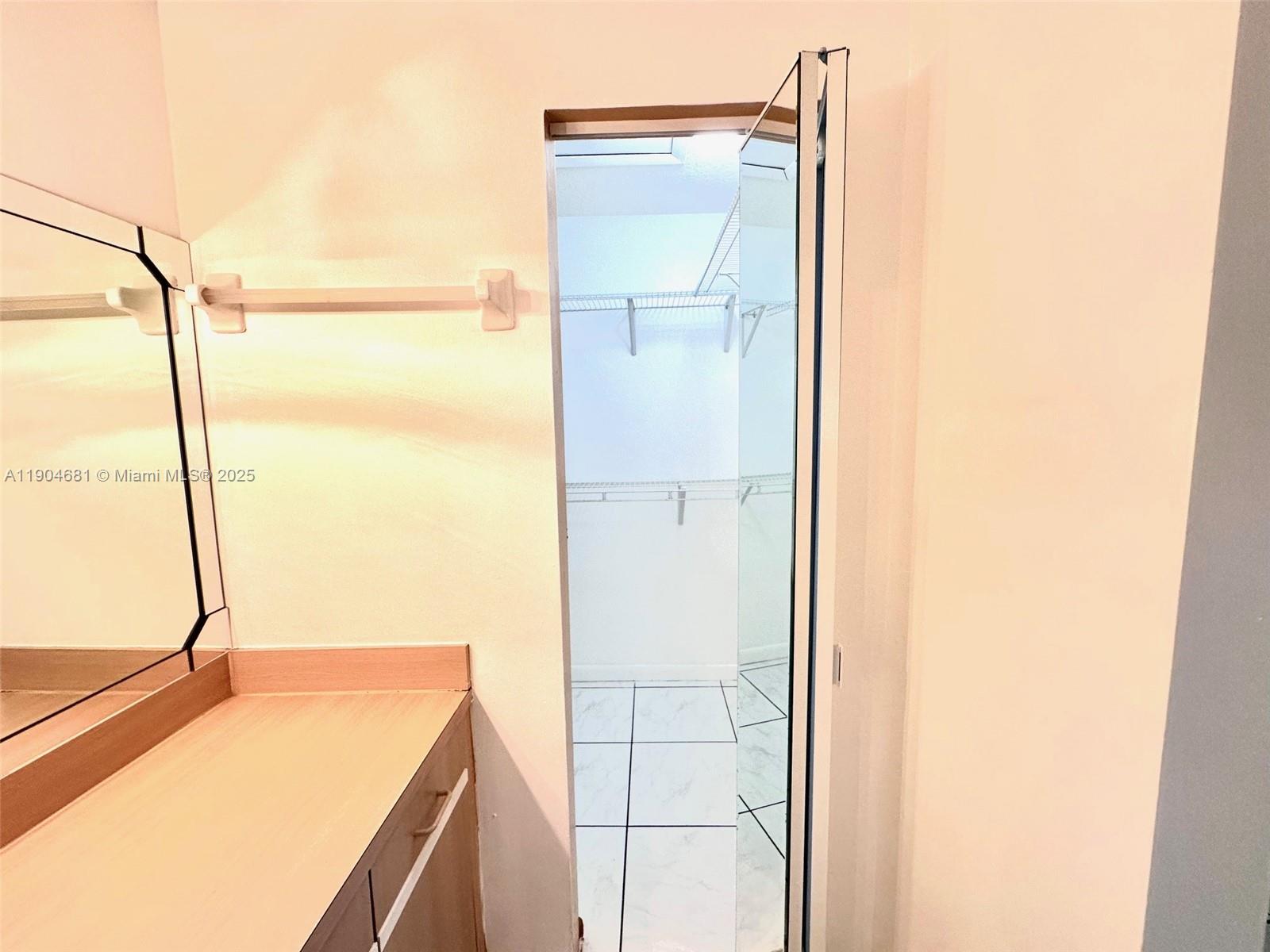 7680 Southwest 156th Court, Unit B115 Miami, FL 33193 - Photo 9 of 14 a view of a bathroom with a sink and a mirror