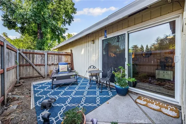 a backyard of a house with barbeque oven table and chairs