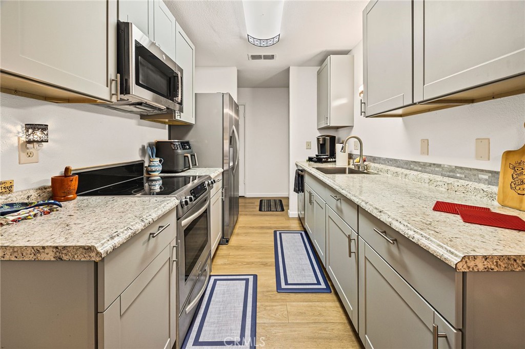 1397 Nord Avenue Chico, CA 95926 - Photo 7 of 18 a kitchen with stainless steel appliances granite countertop a sink stove and refrigerator