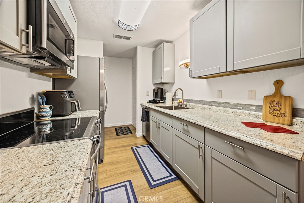 1397 Nord Avenue Chico, CA 95926 - Photo 8 of 18 a kitchen with stainless steel appliances granite countertop a sink and cabinets