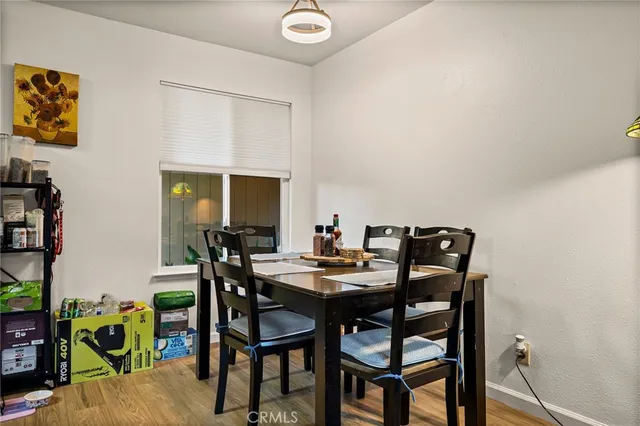a view of a dining room with furniture and a window