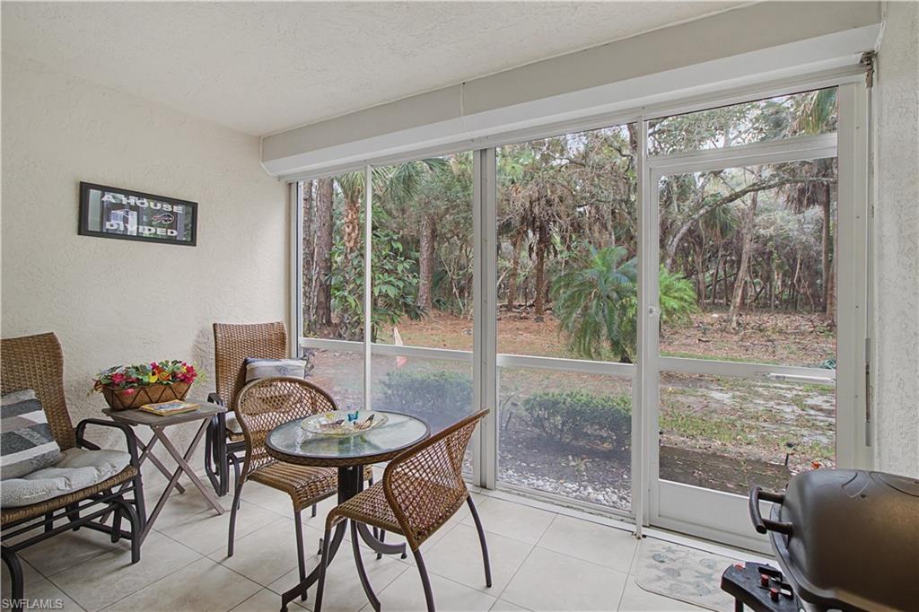 741 Landover Circle, Unit 102 Naples, FL 34104 - Photo 24 of 27 a view of a dining room with furniture window and outside view