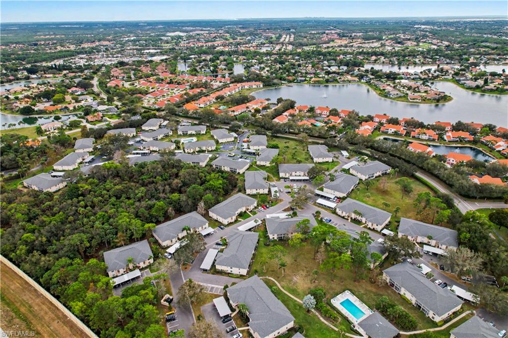 741 Landover Circle, Unit 102 Naples, FL 34104 - Photo 25 of 27 an aerial view of a city with lots of residential buildings