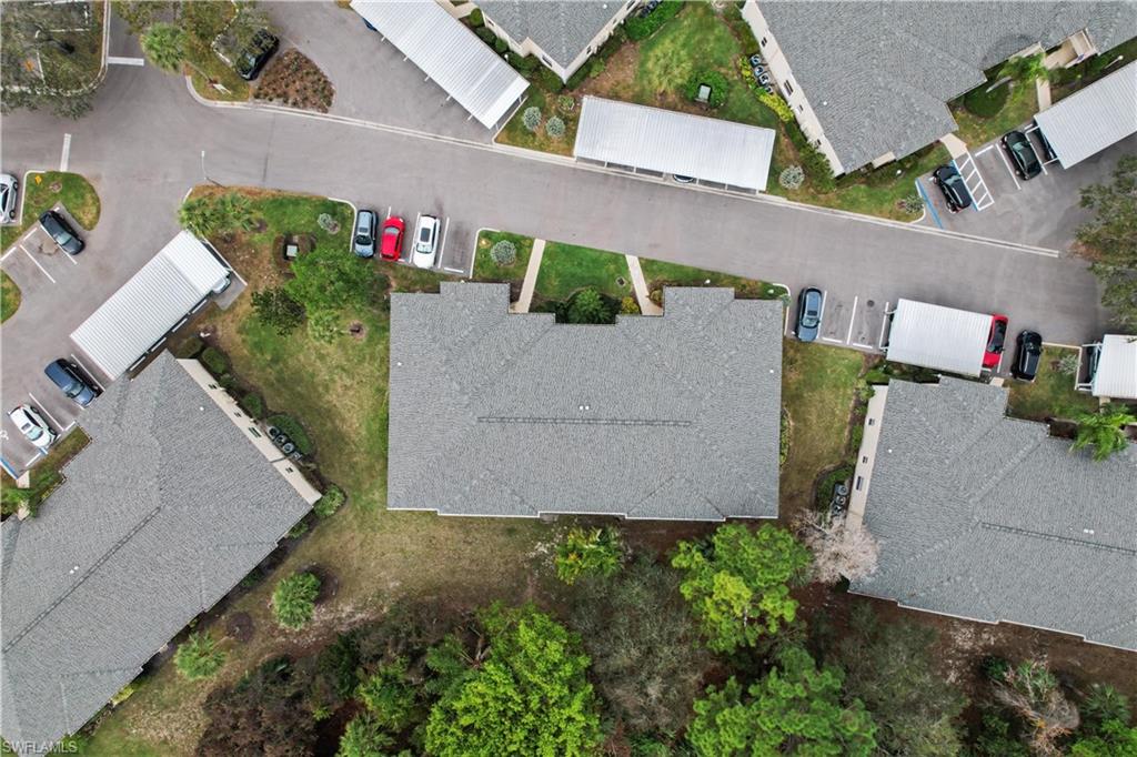 741 Landover Circle, Unit 102 Naples, FL 34104 - Photo 3 of 27 an aerial view of a house with a yard and a garage
