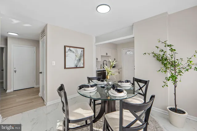 a view of a dining room with furniture and potted plant