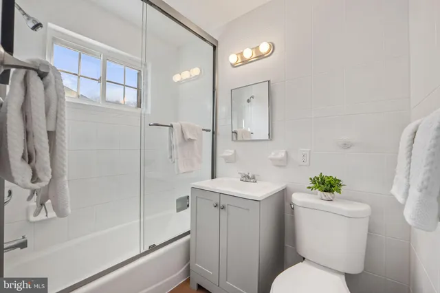a white toilet sitting next to a bathroom sink