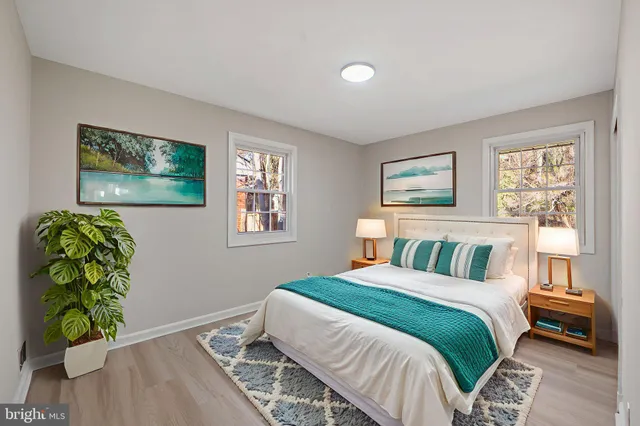 a bedroom with a bed and a painting on the wall